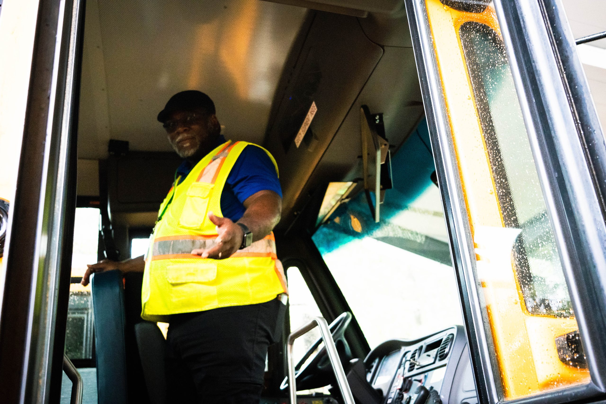 Craig Burch stands by the driver's seat of his electric bus.